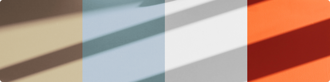 Four paint colours on a wall with a shadow across them