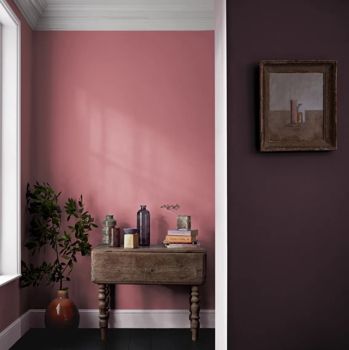 A hallway with a rich dominant purple against a rose pink