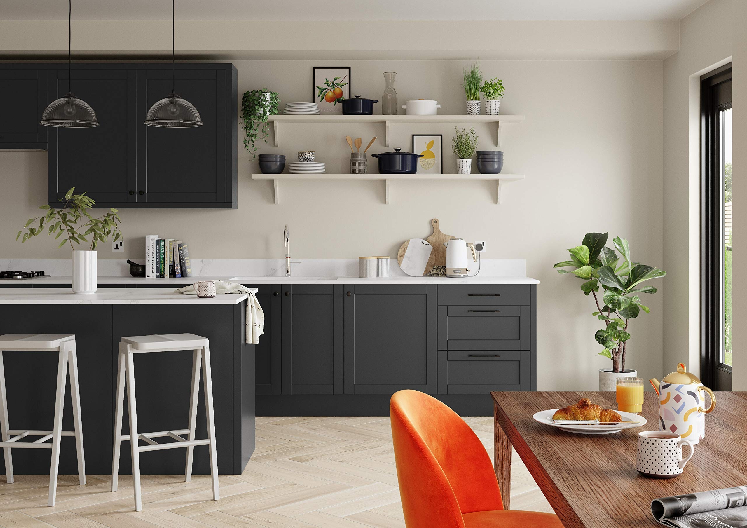 A stylish kitchen with dark cabinets and neutral walls with a bright orange chair